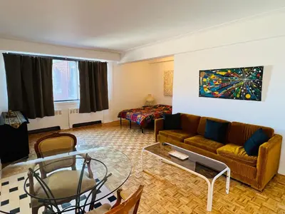 a living room with a couch and a table at Modern City Living in the Golden Square Mile in Montréal