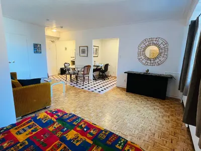 a living room with a couch and a table at Modern City Living in the Golden Square Mile in Montréal
