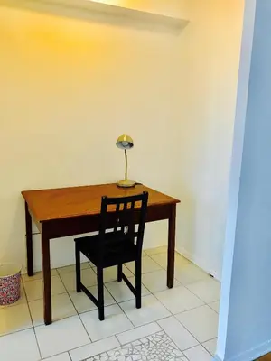 a wooden table with a chair and a lamp on it at Modern City Living in the Golden Square Mile in Montréal