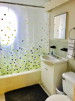 a bathroom with a tub and a sink and a toilet at Modern City Living in the Golden Square Mile in Montréal