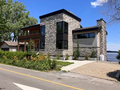 a stone house on the side of a road at Modern apartment with magnificent views in Vaudreuil-Dorion
