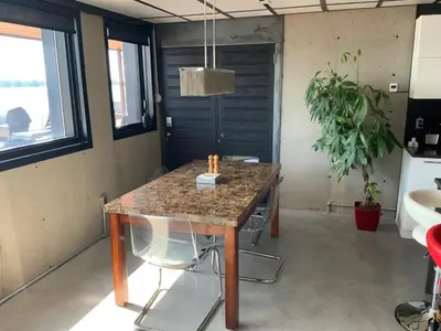 a table in a room with a table and chairs at Modern apartment with magnificent views in Vaudreuil-Dorion