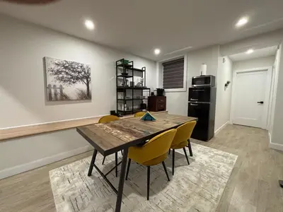 a dining room with a table and yellow chairs at Stylish Condo AC Wi-Fi Westmount Smart TV in Montréal