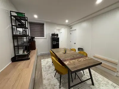 a dining room with a wooden table and yellow chairs at Stylish Condo AC Wi-Fi Westmount Smart TV in Montréal