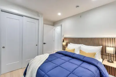 a bedroom with a large blue bed in it at Stylish Condo AC Wi-Fi Westmount Smart TV in Montréal
