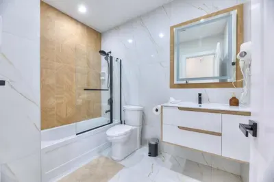 a bathroom with a toilet and a sink and a shower at Stylish Condo AC Wi-Fi Westmount Smart TV in Montréal