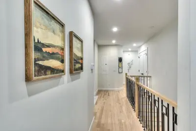 a hallway with three paintings on the walls at Stylish Condo AC Wi-Fi Westmount Smart TV in Montréal