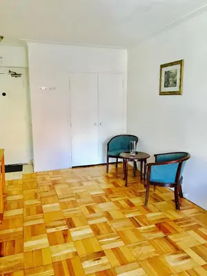 a room with two chairs and a table on a wooden floor at Modern Apartment City Living in the Golden Square Mile in Montréal