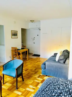 a bedroom with a bed and a table and a chair at Modern Apartment City Living in the Golden Square Mile in Montréal