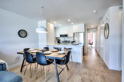 a kitchen and dining room with a table and chairs at Tiny Penthouse Big Balcony Central & Cozy in Montréal