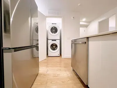 a laundry room with a washer and dryer in it at Tiny Penthouse Big Balcony Central & Cozy in Montréal
