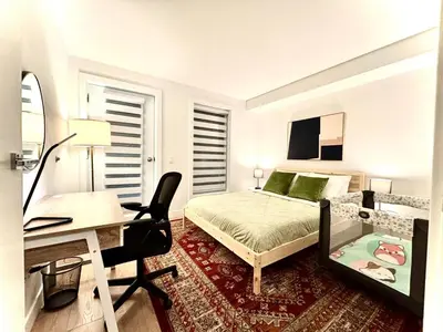 a bedroom with a bed and a desk and a desk at Tiny Penthouse Big Balcony Central & Cozy in Montréal