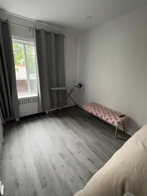 a bedroom with a bed and a table and a window at Shope & Stay Central 7 in Montréal