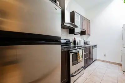a kitchen with a large stainless steel refrigerator at Sunny Open Loft in Montréal