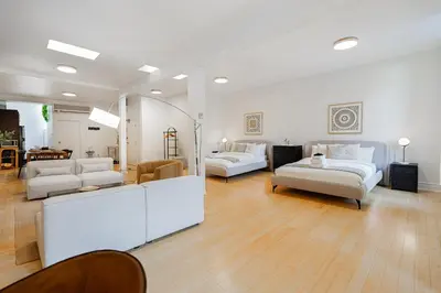 a living room with two couches and a table at Sunny Open Loft in Montréal