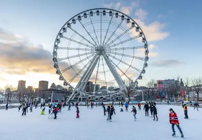 a large ferris wheel and a group of people ice skating at 80m2 Vieux-Montreal, CHUM & metro 1 min, Parking in Montréal