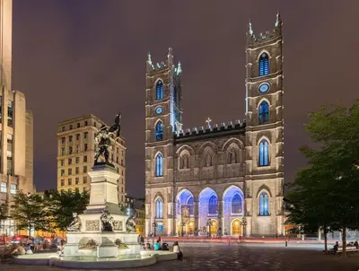 a cathedral with a statue in front of it at night at 80m2 Vieux-Montreal, CHUM & metro 1 min, Parking in Montréal