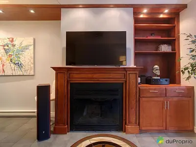 a living room with a fireplace with a flat screen tv at 80m2 Vieux-Montreal, CHUM & metro 1 min, Parking in Montréal