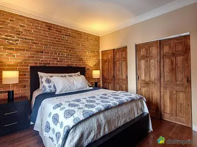a bedroom with a bed and a brick wall at 80m2 Vieux-Montreal, CHUM & metro 1 min, Parking in Montréal