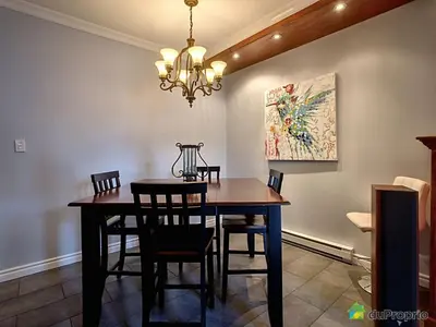 a dining room with a table and chairs and a chandelier at 80m2 Vieux-Montreal, CHUM & metro 1 min, Parking in Montréal