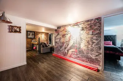 a room with a wall with a brick wall at Cohabs Montréal in Montréal