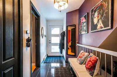 a hallway with a room with purple walls and a couch at Cohabs Montréal in Montréal