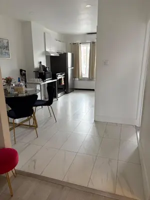 a kitchen and living room with a table and chairs at Shop & Stay Central 8 in Montréal