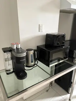 a glass counter top with a coffee maker and a coffee machine at Shop & Stay Central 8 in Montréal