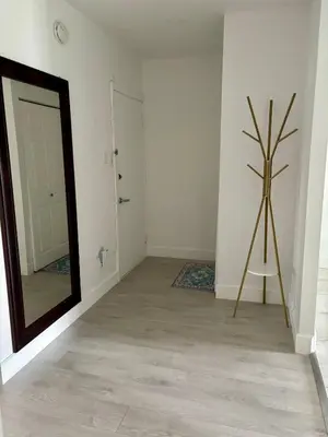 a room with a mirror and a tripod next to a door at Shop & Stay Central 8 in Montréal