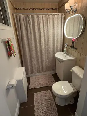 a small bathroom with a toilet and a sink at Shop & Stay Central 6 in Montréal