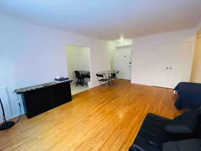 an empty living room with a table and a couch at Modern City Apartment Living in the Golden Square Mile in Montréal