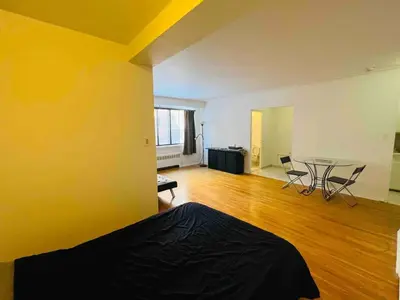 an empty room with a table and chairs in it at Modern City Apartment Living in the Golden Square Mile in Montréal
