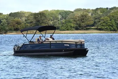 two people in a blue boat on a lake at Private Boat Tour Montreal in Boucherville