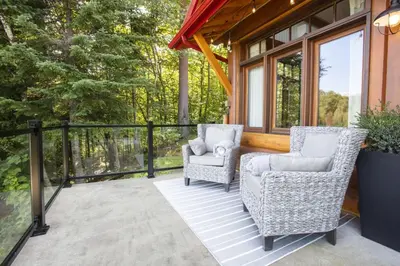 two chairs sitting on a screened in porch at Log cabin - Lakeside - Le Oly in Saint Romain