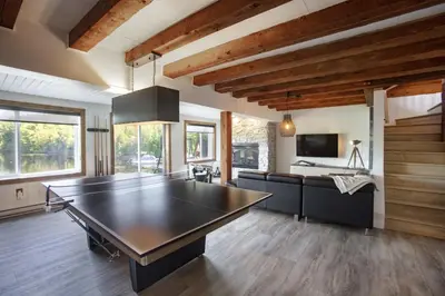 a large living room with a ping pong table at Log cabin - Lakeside - Le Oly in Saint Romain