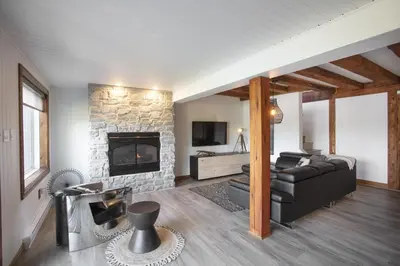 a living room with a couch and a fireplace at Log cabin - Lakeside - Le Oly in Saint Romain