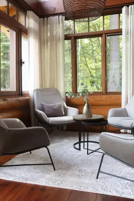 a living room with two chairs and a table at Log cabin - Lakeside - Le Oly in Saint Romain