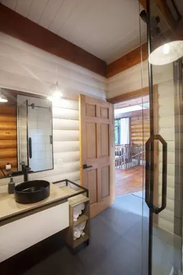 a bathroom with a sink and a mirror at Log cabin - Lakeside - Le Oly in Saint Romain