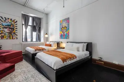 a bedroom with two beds and a couch at 4 Stylish Lofts in Old Montreal in Montréal