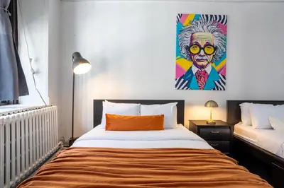 a bedroom with a bed with a painting on the wall at 4 Stylish Lofts in Old Montreal in Montréal