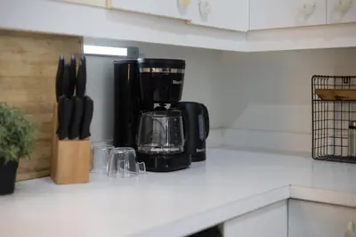 a kitchen counter with a coffee maker and utensils at 4 Stylish Lofts in Old Montreal in Montréal