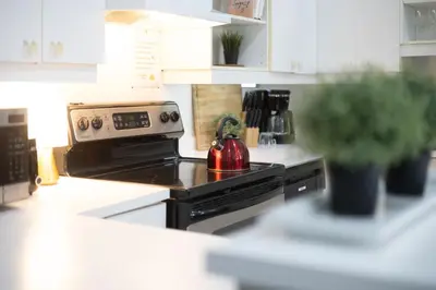 a kitchen with a stove with a tea kettle on it at 4 Stylish Lofts in Old Montreal in Montréal