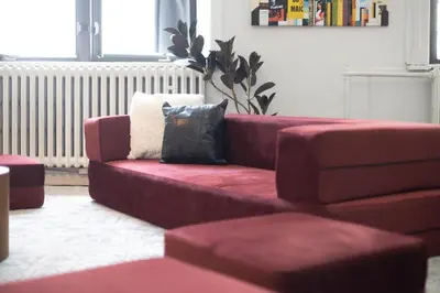 a red couch sitting in a living room at 4 Stylish Lofts in Old Montreal in Montréal