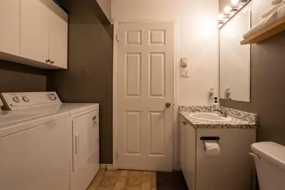 a bathroom with a sink and a white door at 4 Stylish Lofts in Old Montreal in Montréal