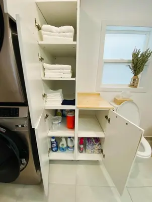 a bathroom with a white cabinet with towels at Great Gaston in Longueuil