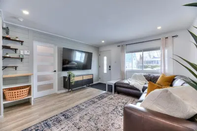 a living room with a couch and a tv at Great Gaston in Longueuil