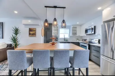 a kitchen with a large wooden table and chairs at Great Gaston in Longueuil