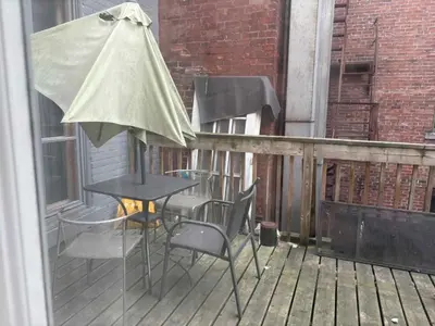 a table and chairs and an umbrella on a balcony at Spacious apartment in dowtown Montreal in Montréal