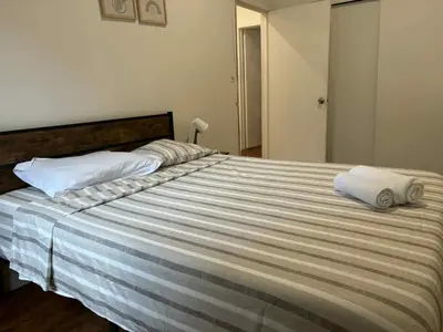 a large bed with two towels on top of it at Spacious apartment in dowtown Montreal in Montréal