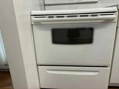 a white stove top oven in a kitchen at Spacious apartment in dowtown Montreal in Montréal